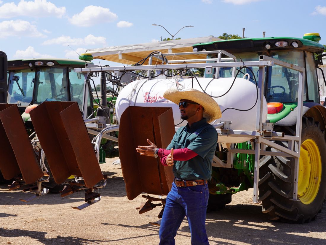 Explaining weed control equipment mounted on a tractor