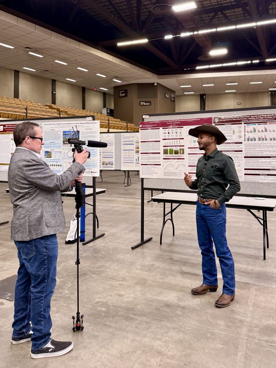 Being interviewed on camera beside a research poster